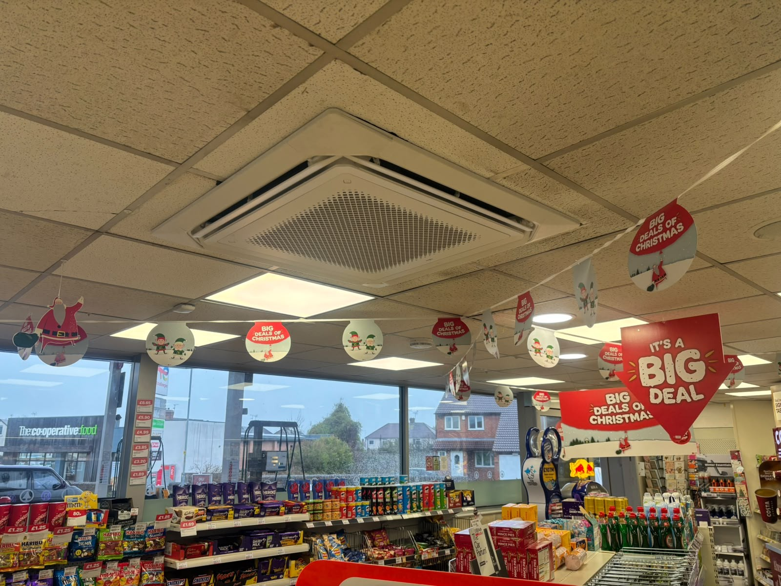 Ceiling cassette ventilation and air conditioning unit installed in a convenience store ceiling grid