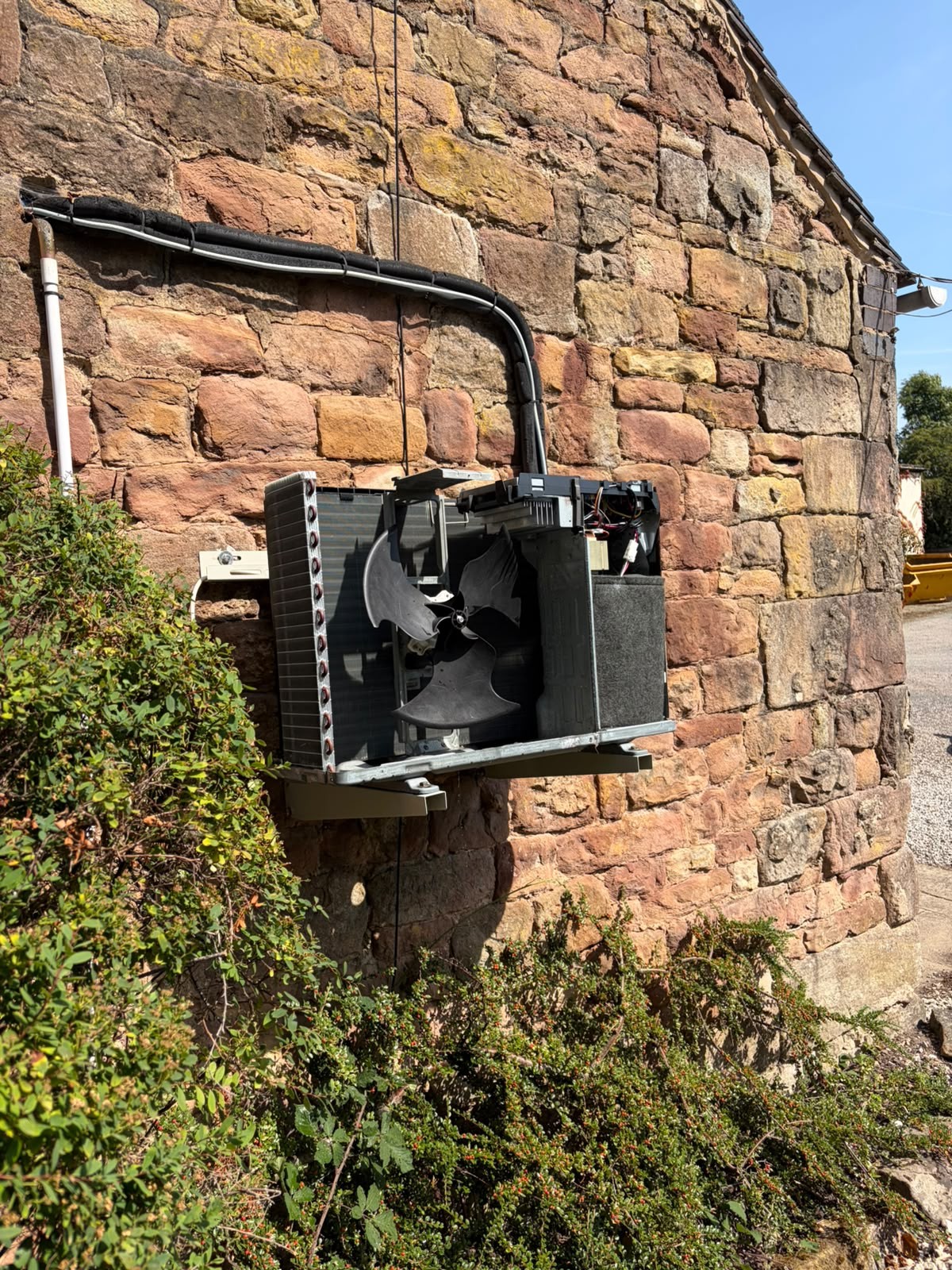 Air conditioning breakdown repair underway with the outdoor unit casing removed